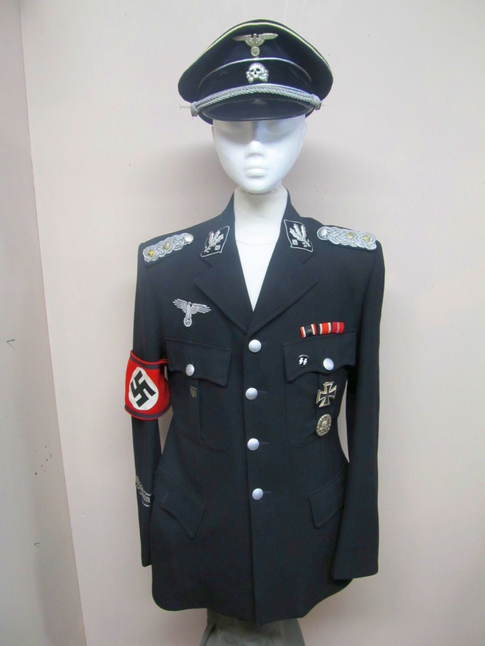 A modern copy of a Gestapo uniform to include hat, jodhpurs and ammo pouch. .