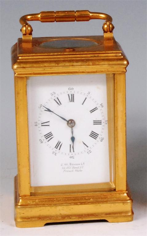 A circa 1900 gilt brass carriage clock, having gorge case, the white enamel signed J W Benson Ltd,