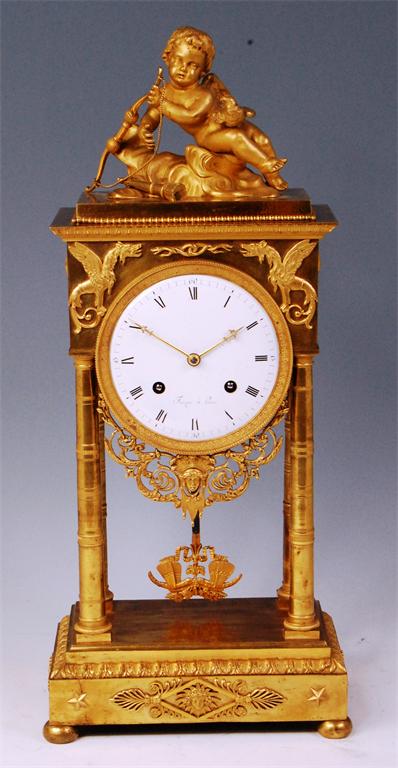 A French Empire period gilt bronze portico clock by Faizan of Paris, the whole surmounted with