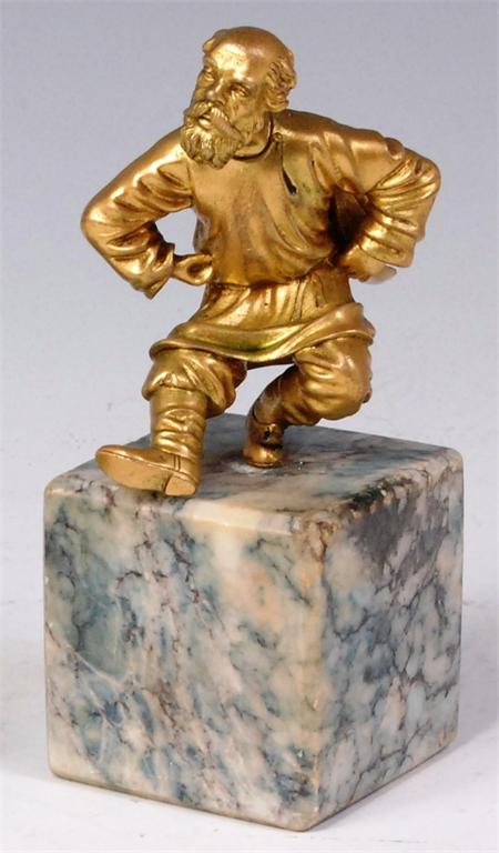 A circa 1900 Russian gilt bronze figure of a dancing man, raised on variegated marble square section
