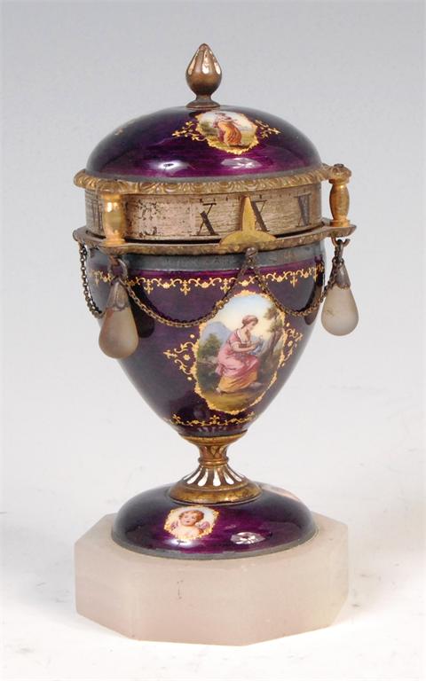 A circa 1900 Austrian guilloche enamel revolving dial timepiece modelled as a pedestal urn, having