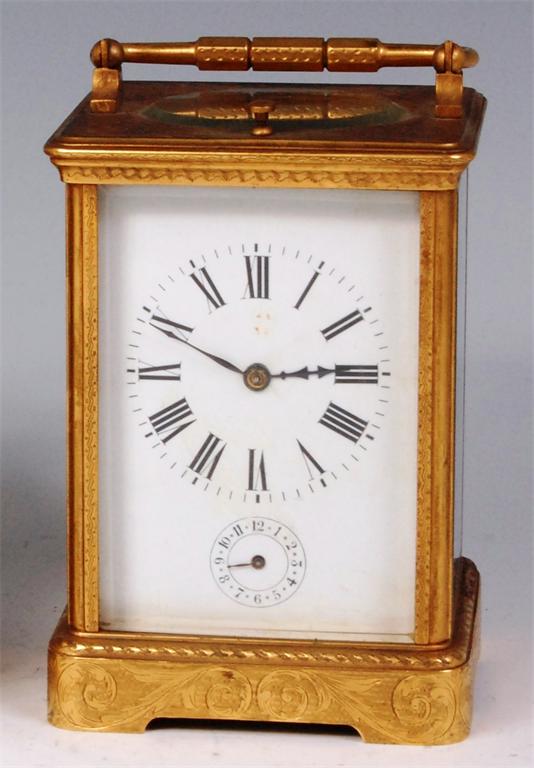 A late 19th century French Grand Sonnerie gilt brass carriage clock, the white enamel dial having