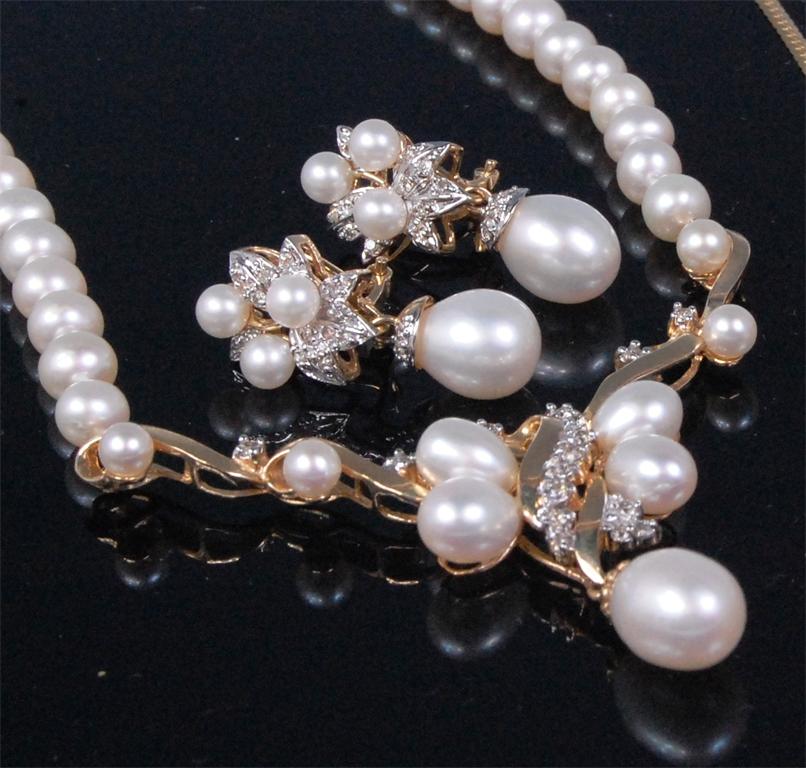A contemporary 14ct gold pearl and diamond set necklet, the pendant claw set with small brilliant