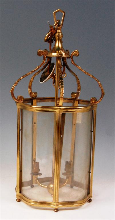 A lacquered brass and glazed ceiling lantern, of shaped and panelled cylindrical form, with three