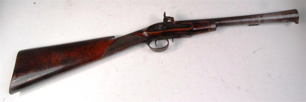 An 18th century English blunderbuss, having converted percussion cap action, engraved lockplate