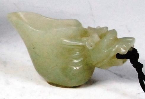 A Chinese carved jade Netsuke of a small drinking vessel, with animal mask, 6cm