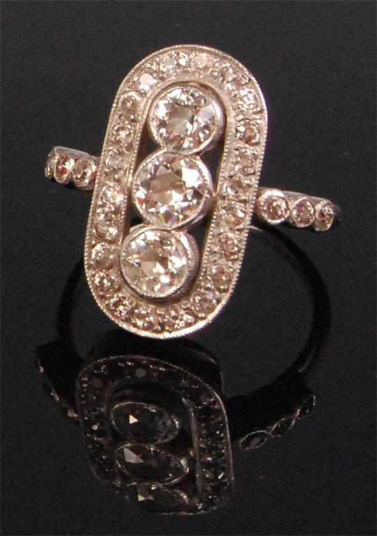 An Art Deco ladies platinum and diamond cocktail ring, having three centre brilliants, the largest