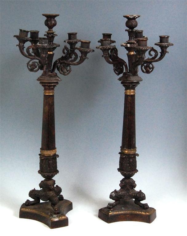 A pair of neo-Classical bronze six light candelabra, each having centre raised candle holder flanked