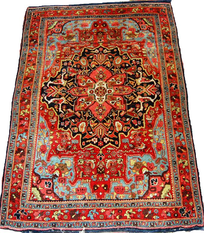 A Persian woollen rug, having a central stylised medallion within trailing tramline borders, 165 x