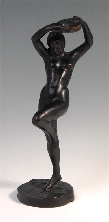 A mid 20th century solid bronze full length standing nude tambourine player, raised on integral