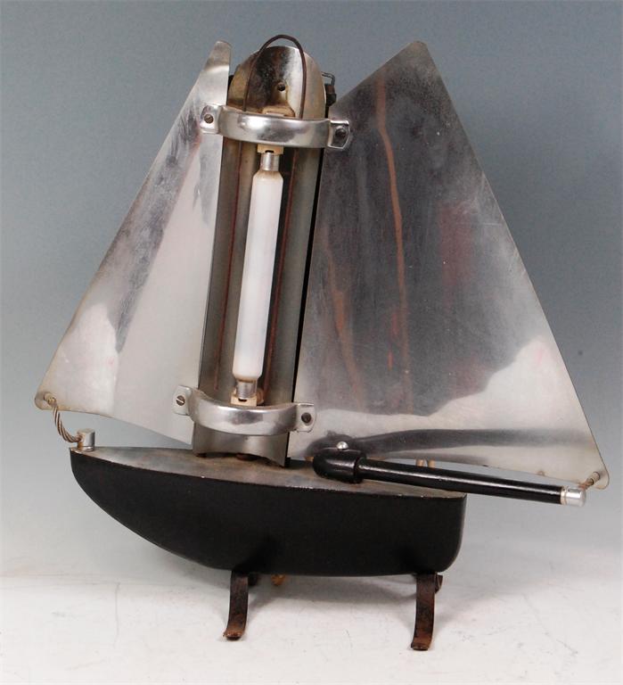 A mid-20th century part black enamelled metal table lamp, in the form of a yacht, by the Bunting