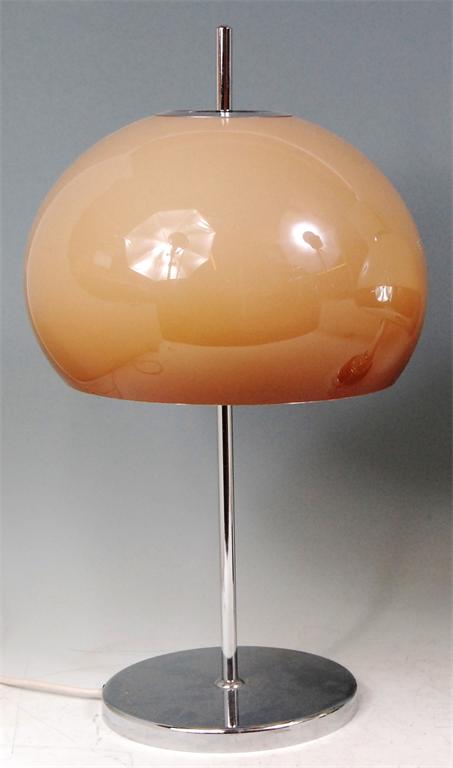 A Harvey Guzzini table lamp, having typical domed plastic shade over a chromed steel base, h.54cm