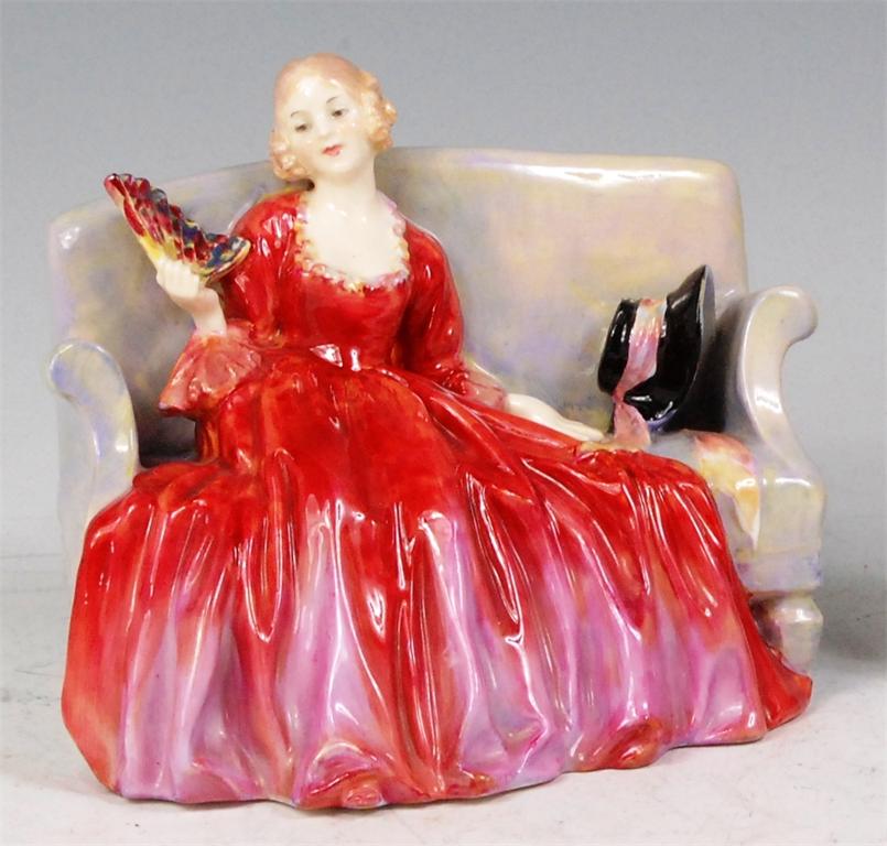 A Royal Doulton painted and glazed ceramic figurine 'Sweet and 20', the young woman modelled as