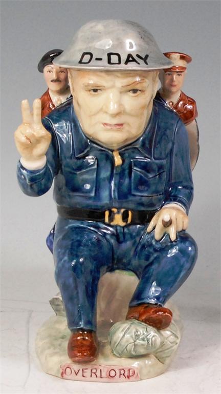 A modern Kevin Francis glazed ceramic figure of Winston Churchill, in seated pose and making the V