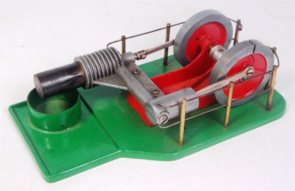 Stirling hot air engine, make of cast metal in green and red. Sold with alcohol burning tray and