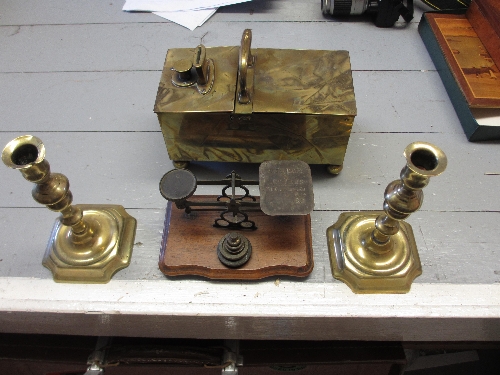 Pair of antique brass candlesticks, pair of brass postal scales, a brass money box and miscellaneous