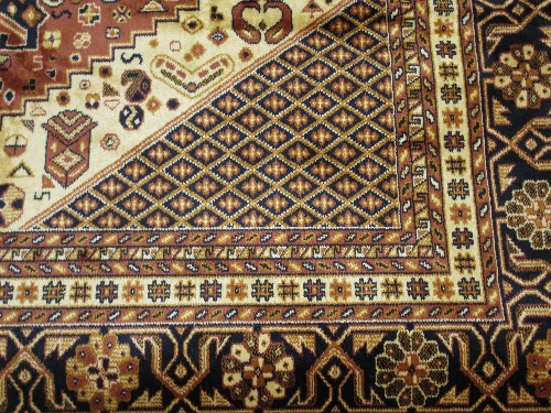 Caucasian design carpet on beige ground, 2.3m x 1.6m