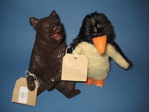 Carved Black Forest perfume bottle holder in the form of a bear together with a soft toy penguin