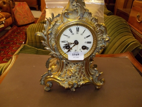 19th Century French gilt brass mantel clock having circular dial with Arabic and Roman numerals, the