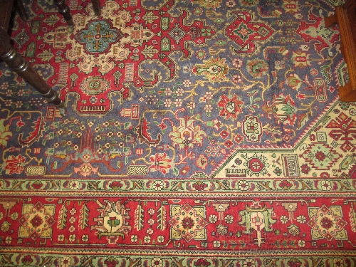 Joshaghan carpet with typical all-over stylised floral design on a red ground with borders, 10ft x