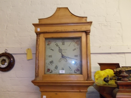 Early 19th Century pine longcase clock, the arched square hood above a similar door and plinth base,