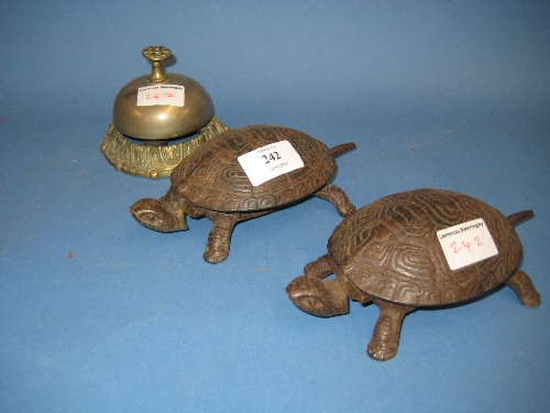 Two Victorian iron counter bells in the form of tortoises, together with another counter bell