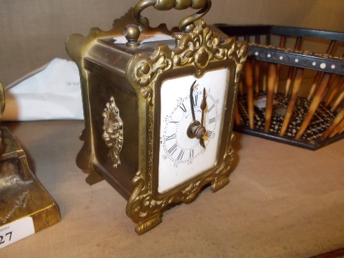Small French brass clock, the enamel dial with Roman and Arabic numerals with two train movement