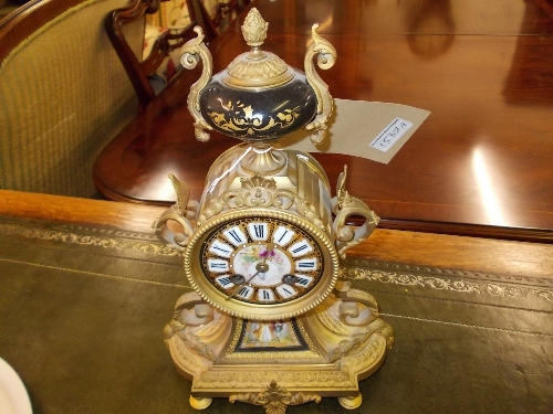 19th Century French gilt metal mantel clock with circular porcelain dial and two train movement