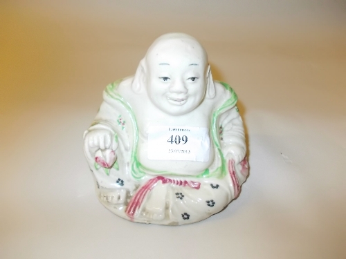 Small figure of a seated Buddha with green and red painted decoration