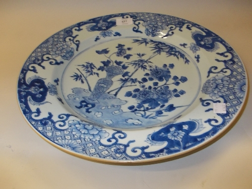 18th Century Chinese blue and white charger decorated with a central vase and flowers within a