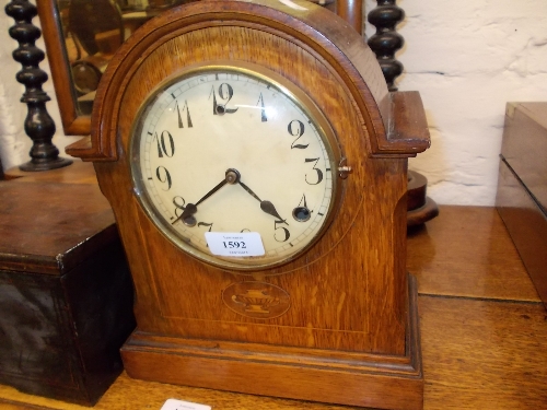 Early 20th Century oak and inlaid dome top mantel clock with circular dial having Arabic numerals