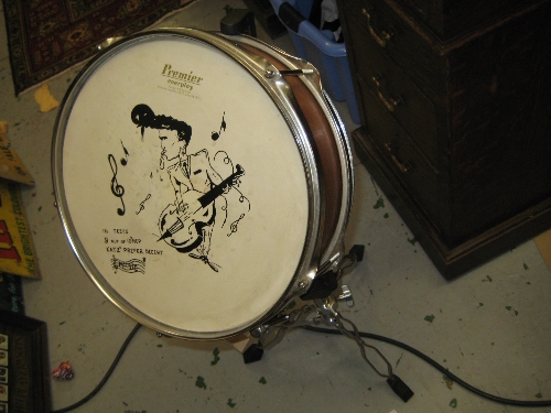 Premier snare drum painted with a figure playing double bass