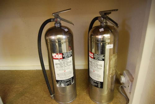 Two modern stainless steel fire extinguishers