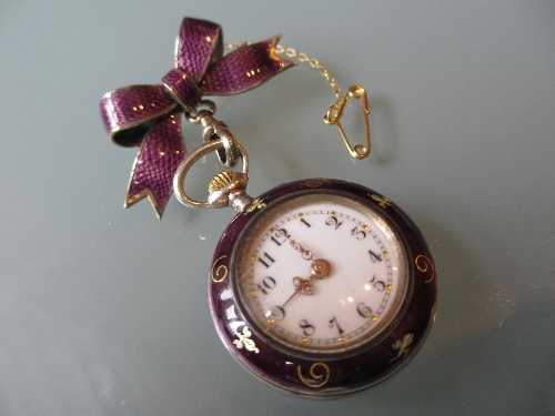 19th Century fob watch with gilt decoration on a mauve enamel ground suspended from a bow