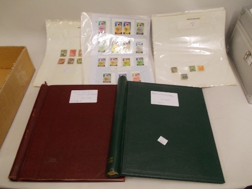 Two albums and three folios of loose leaves containing a quantity of World stamps including: