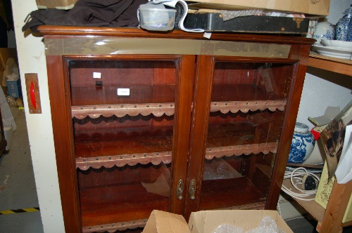 Mahogany bookcase with two glazed doors on a moulded plinth base