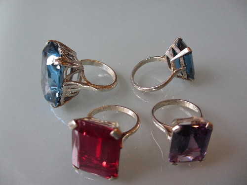 Four various dress rings set coloured stones