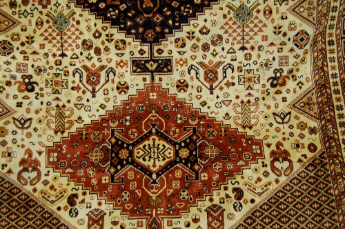 Caucasian design carpet on beige ground, 2.3m x 1.6m