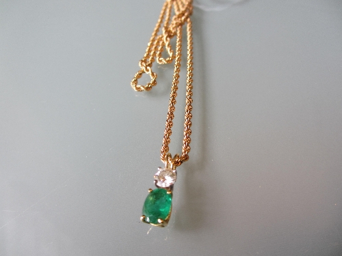 Two stone emerald and diamond pendant on a 9ct rope link chain