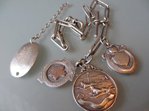 Silver guard chain mounted with three silver medals and a sterling silver bracelet (a/f)