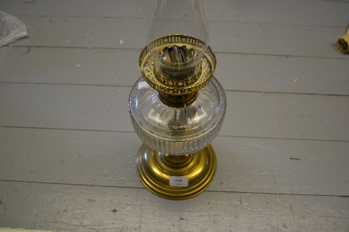 Brass oil lamp with glass well and chimney