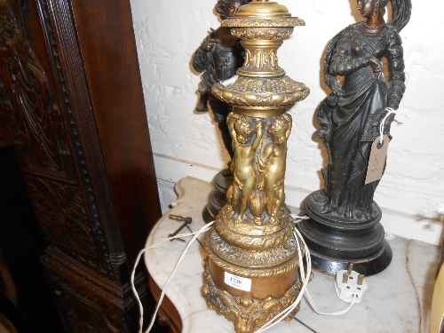 Ormolu table lamp with cherub design column raised on dolphin supports