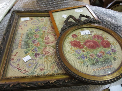 Circular bow surmounted framed needlework picture of flowers, together with two other needlework