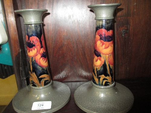 Pair of Moorcroft candlesticks with Tudric pewter mounts, the stems decorated with the Poppy design,