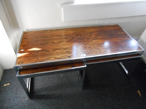 Nest of three mid 20th Century chrome and rosewood coffee tables by Howard Miller Limited, Sussex,