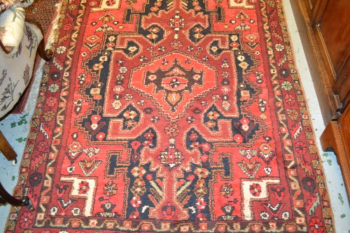 Hamadan rug with medallion design in shades of red and deep blue with borders