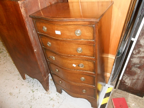 Reproduction narrow chest of five graduated drawers with serpentine front and brass ring handles