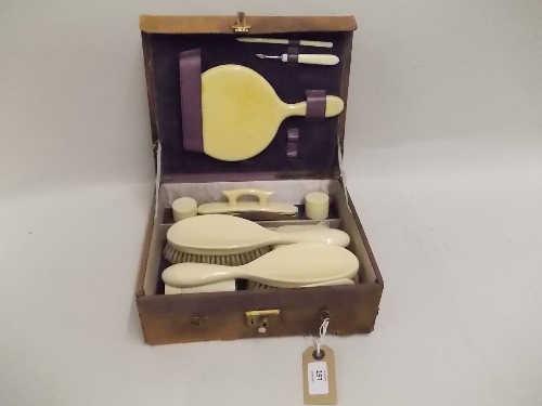 Leather dressing case fitted with a simulated ivory part set and other items