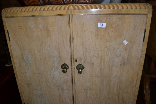 Mid 20th Century bleached figured walnut cocktail cabinet, the gadroon top above a pair of