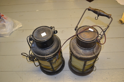 Black painted ship's lantern together with another similar ship's lantern